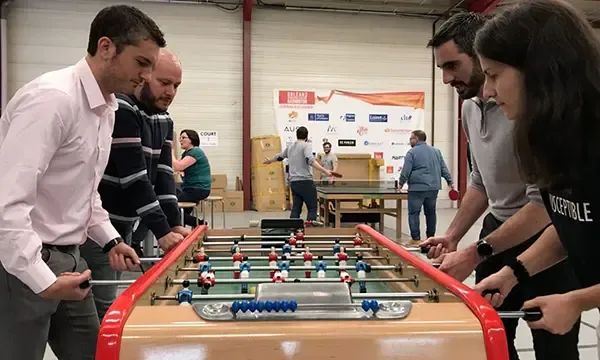 Employees playing table football during a break