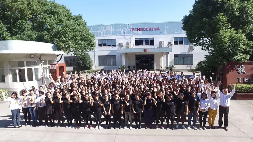 Group photo of the Technochina teams in front of their Shanghai factory