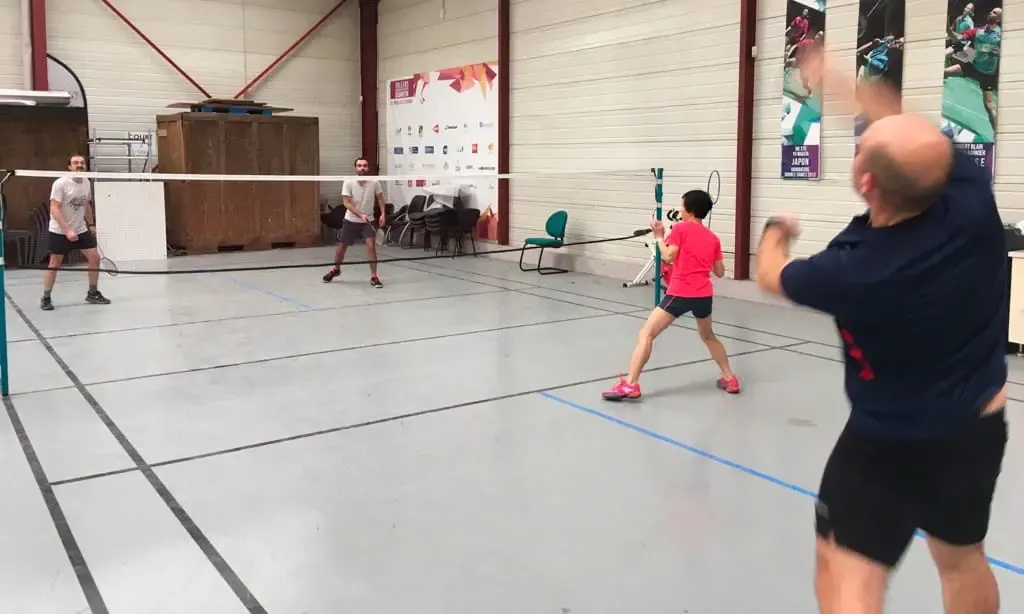 Employees playing badminton on a court marked out in Altyor’s warehouse