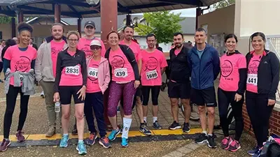 Group of Altyor employees in pink T-shirts with race bibs