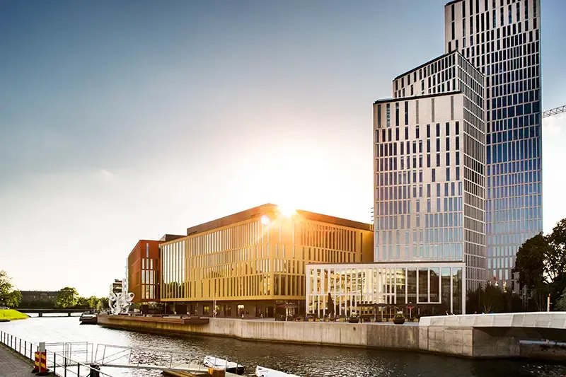 Modern office buildings by the water at sunset