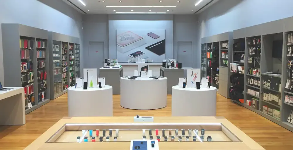High-tech accessories shop with well-stocked shelves and display tables in the centre